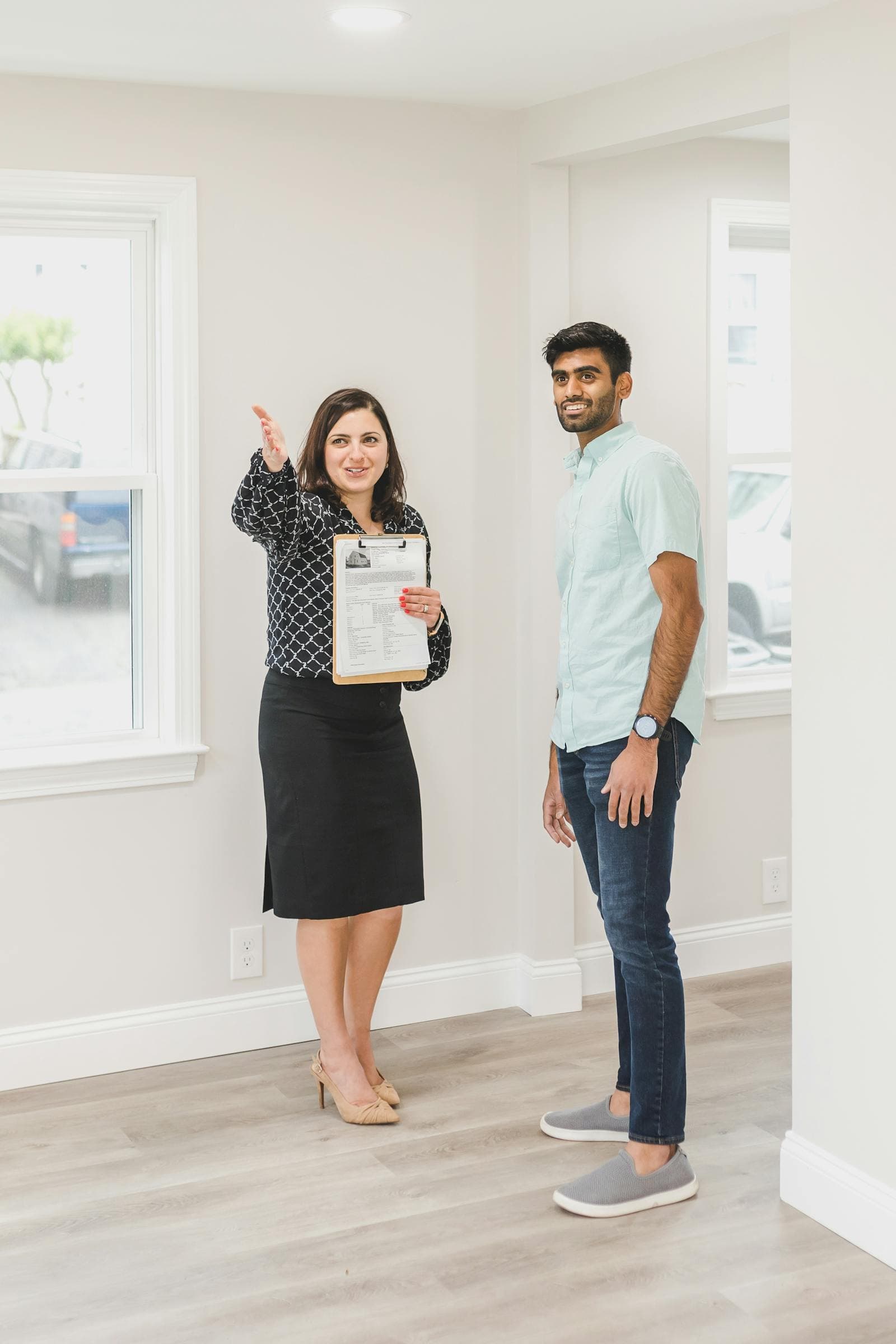Agent and buyer standing inside a property walkthrough