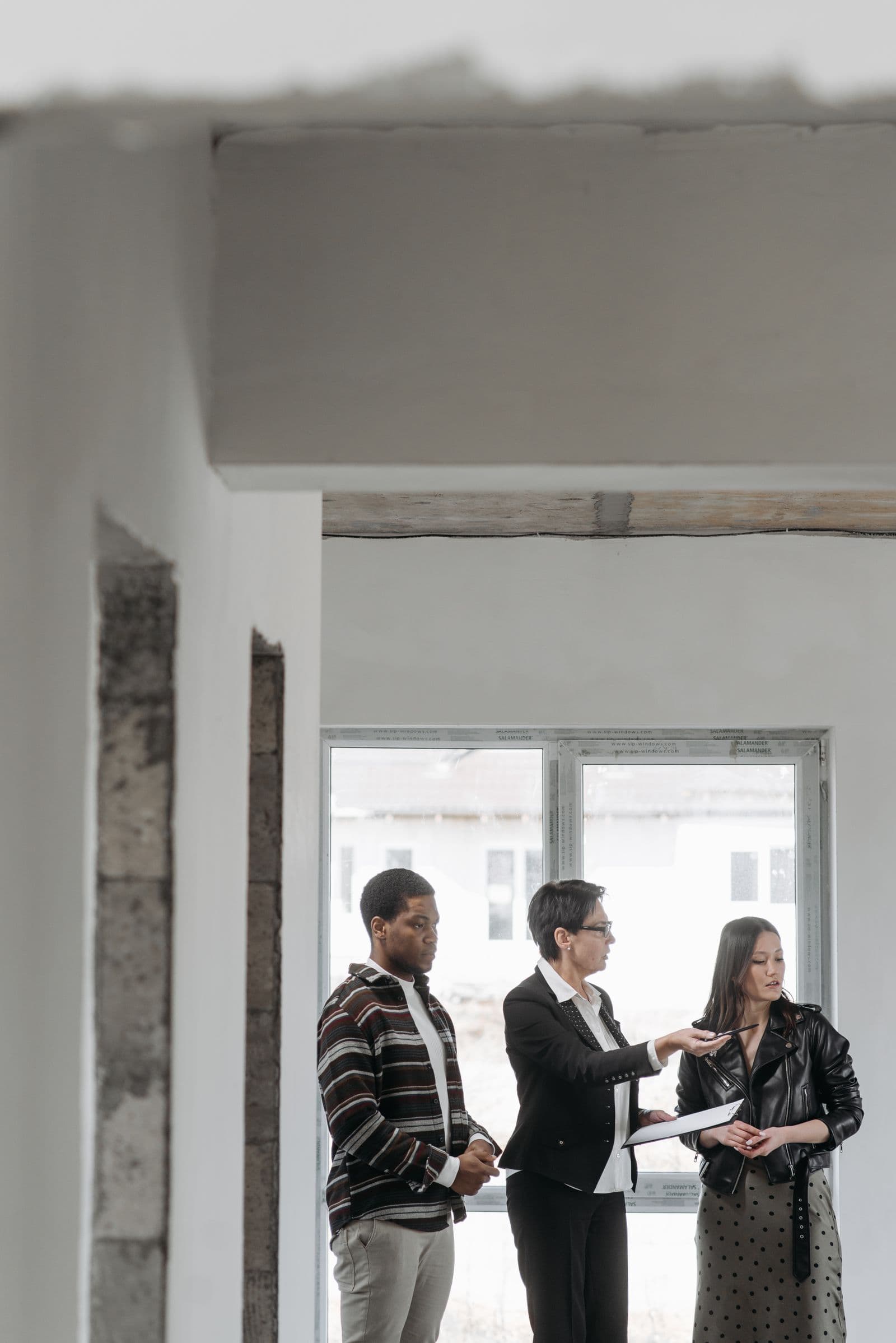 Agent and clients discussing a property during a walkthrough