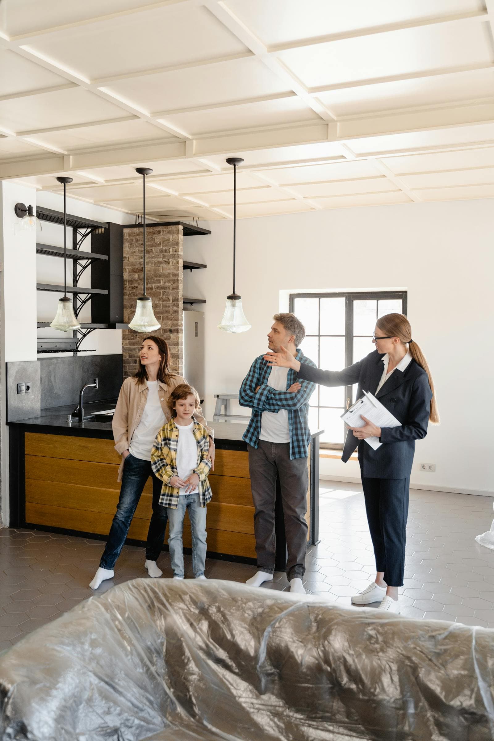 Family touring a home with a real estate agent