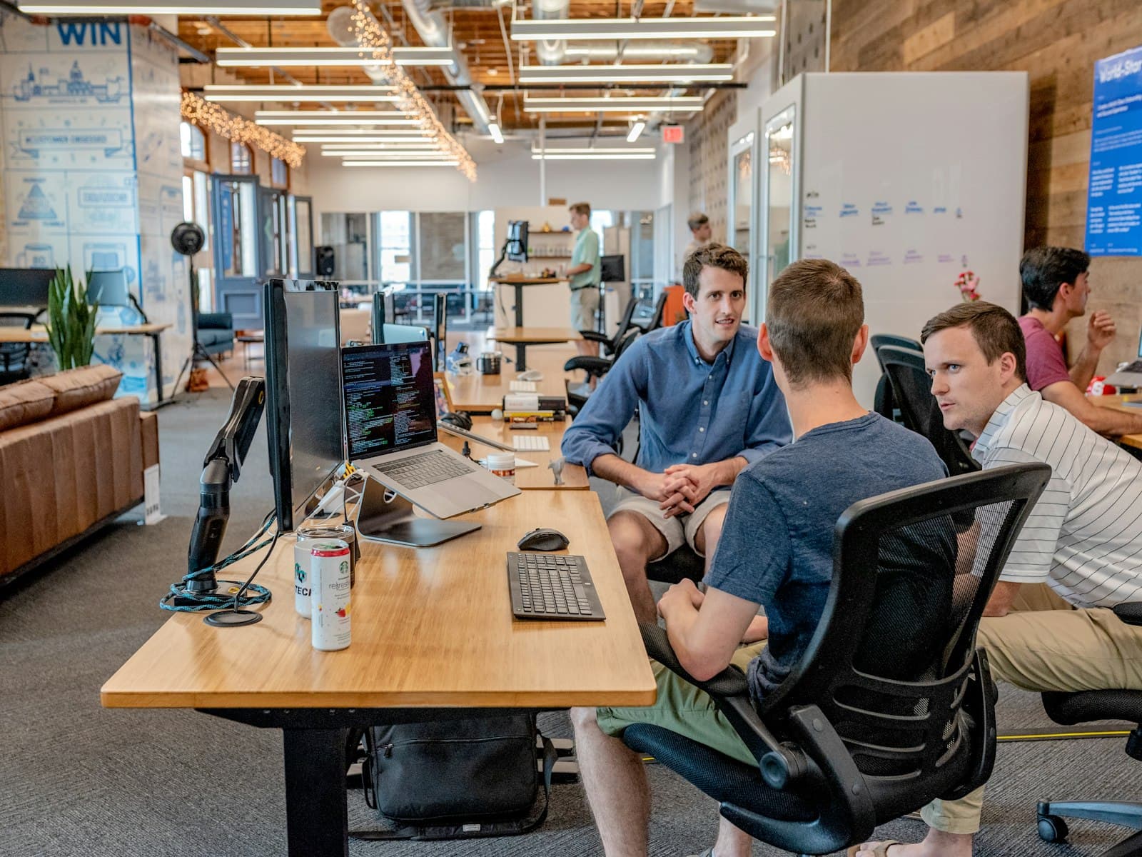 Operators reviewing the next lead handoff at a work table
